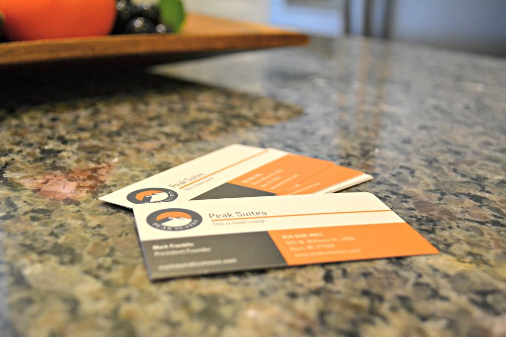 Peak Suites business cards on kitchen counter top